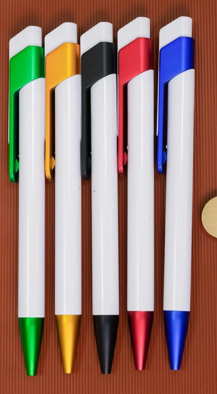 Five white click pens with silver clips and coloured grips, Hensa