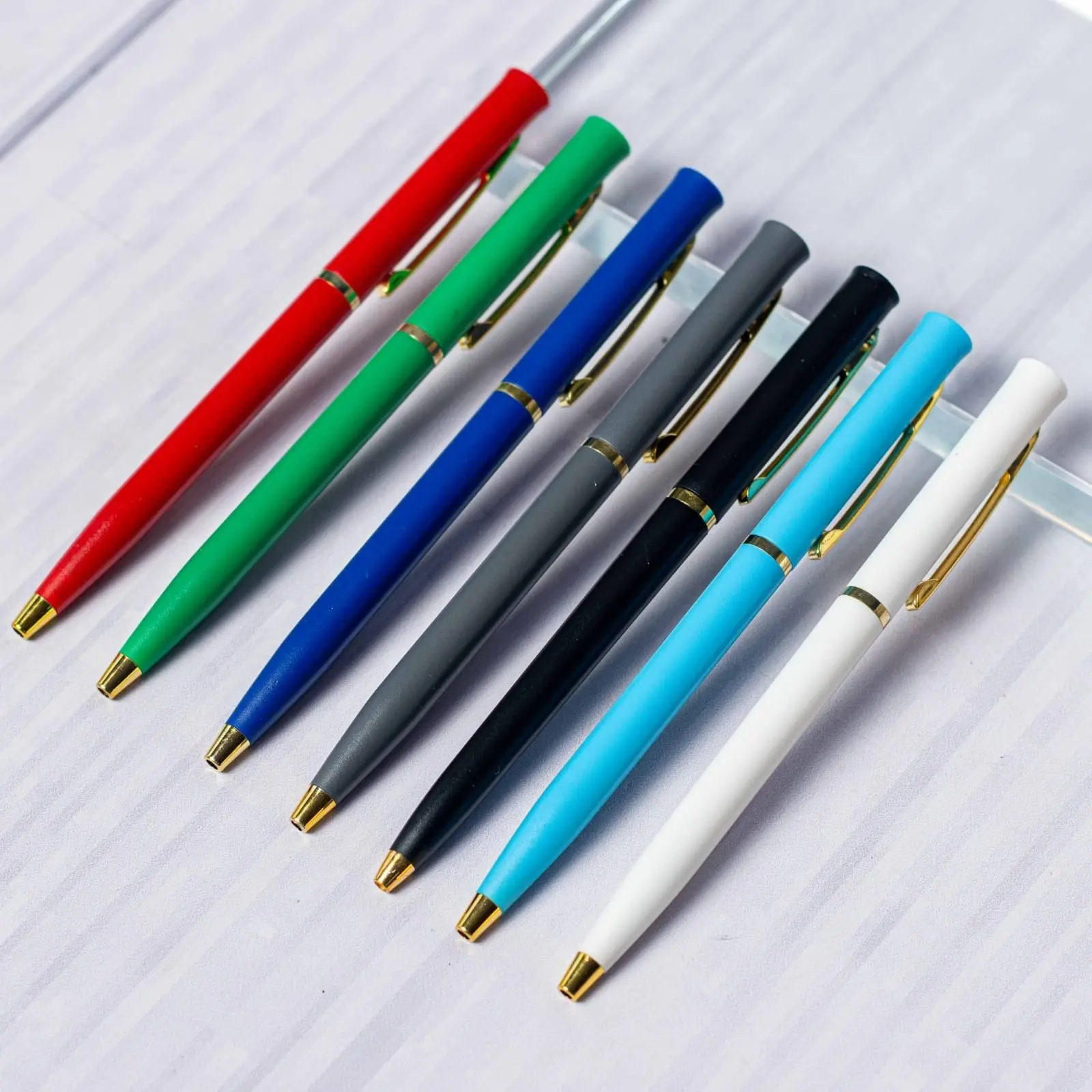 Seven slim twist pens with gold trim in several colours, Hensa
