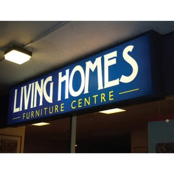 Illuminated blue lightbox shop sign above an entrance, Hensa Lightbox Signages