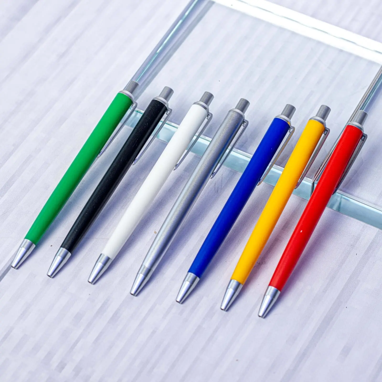 Seven metal click pens with coloured bodies and chrome tops, Hensa