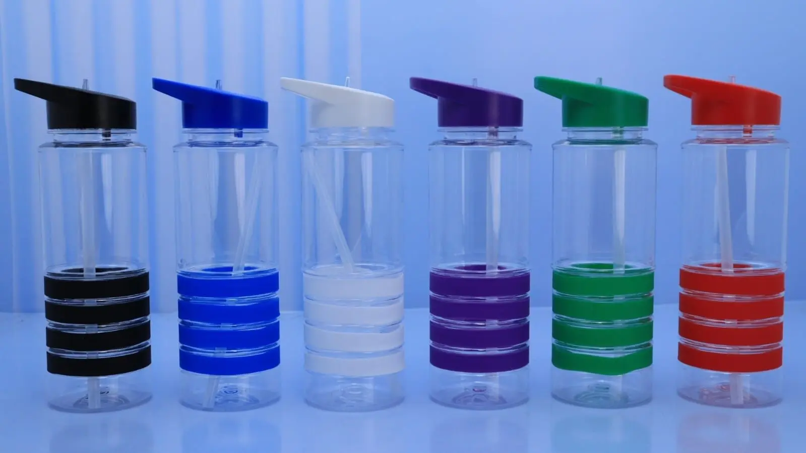 Six clear plastic water bottles with coloured flip lids and bands, Hensa
