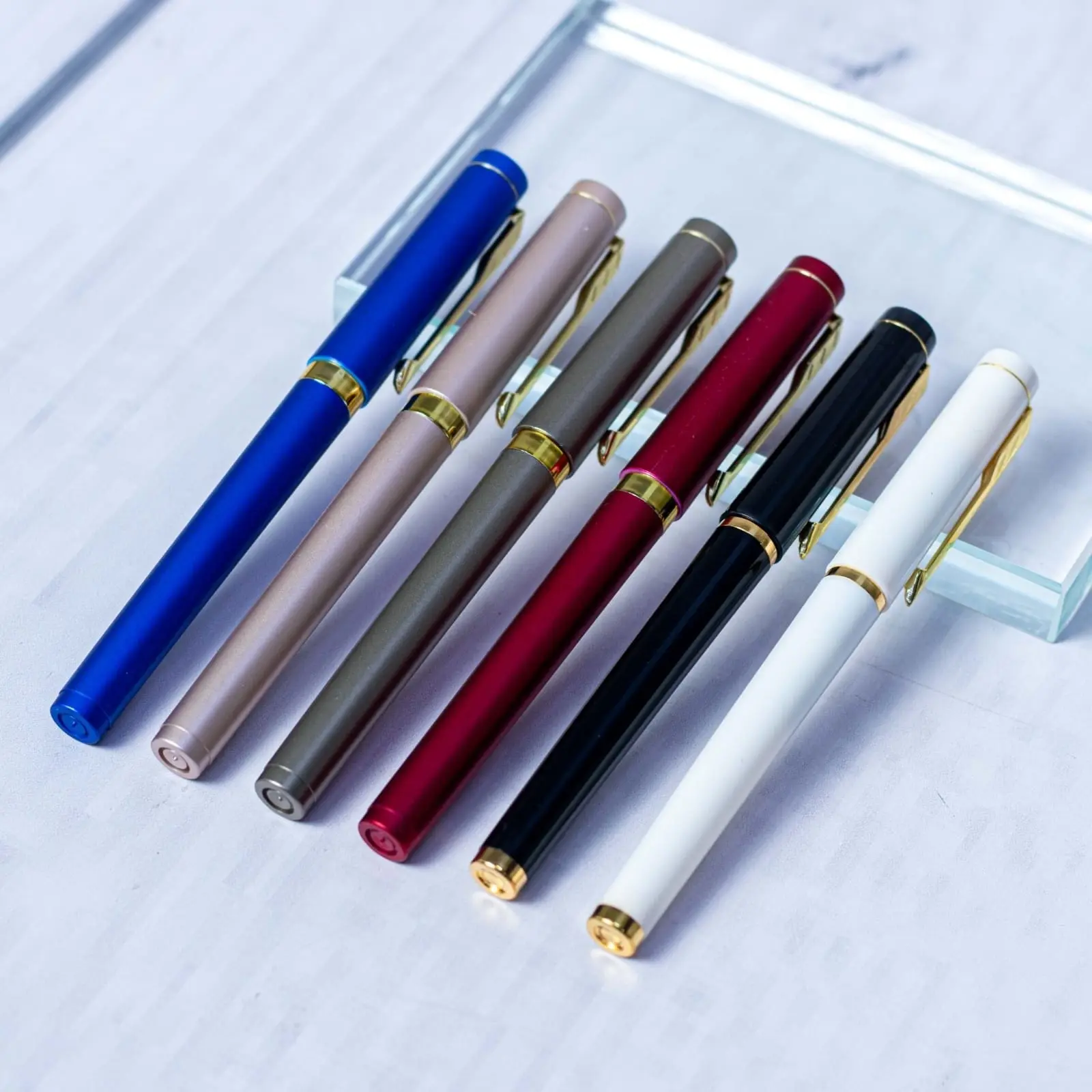 Six executive pens with gold-tone trim in blue, champagne, grey, burgundy, black and white, Hensa