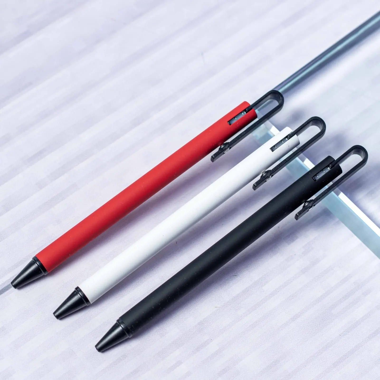 Plastic pens in several colours arranged in a row, Hensa