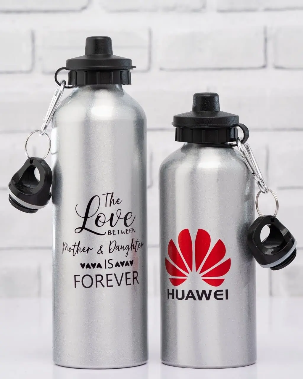 Two silver water bottles, tall and short, with black lids and carabiner clips, Hensa