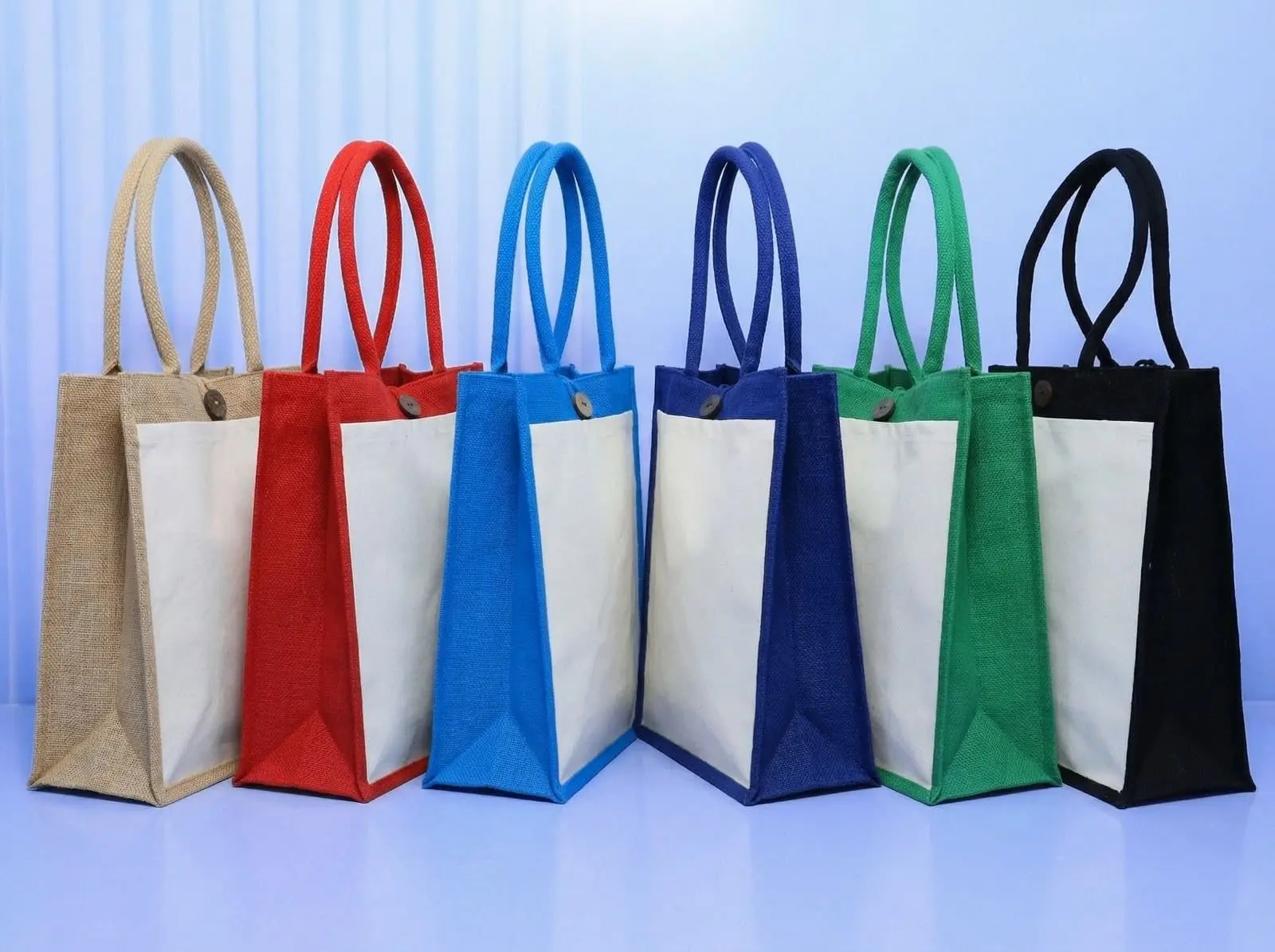 Six A4 jute bags in tan, red, blue, navy, green and black with cream panels and buttons, Hensa