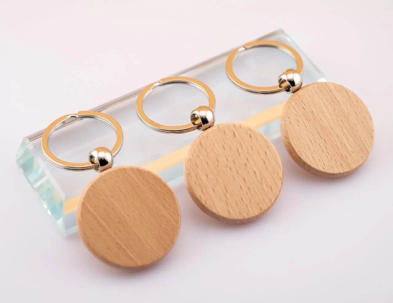 Three round wooden keyholders, Hensa
