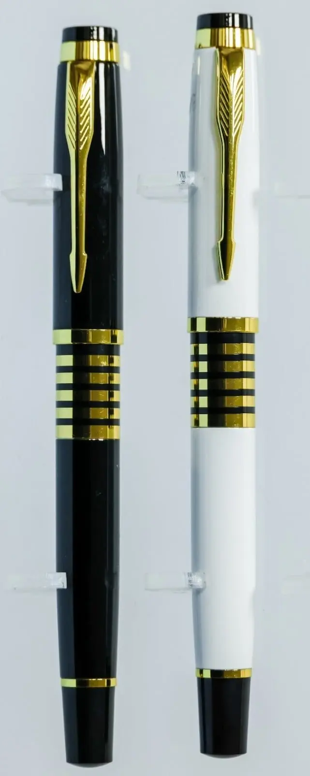Black and white metal pens with gold arrow clips and gold ring bands, Hensa