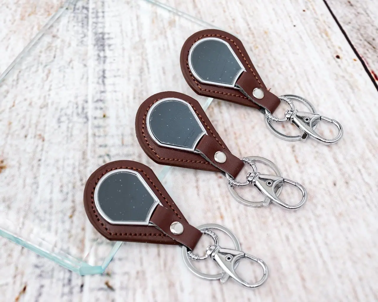 Three brown leather teardrop keyholders, Hensa