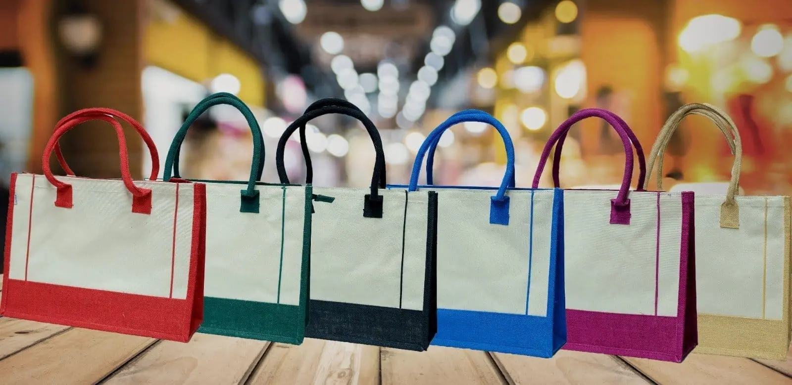 Row of A3 jute bags with cream front panels, coloured jute bases and matching handles, Hensa