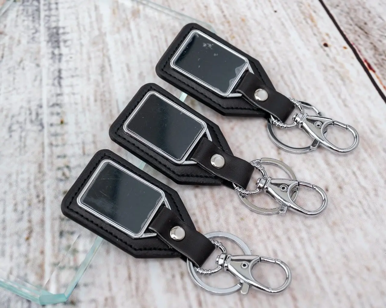 Three black leather shield keyholders, Hensa
