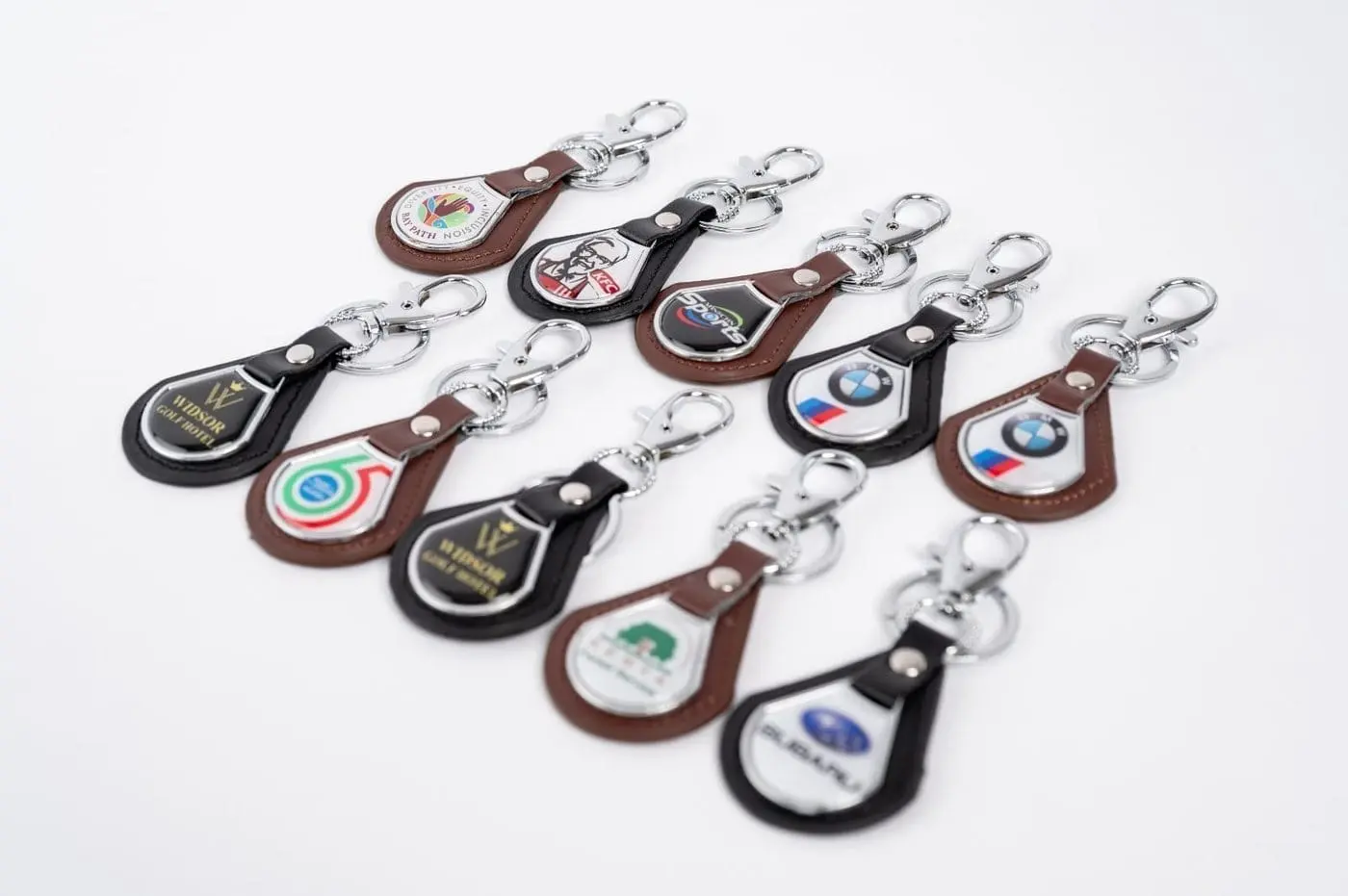 Assorted leather teardrop keyholders with printed badges, Hensa