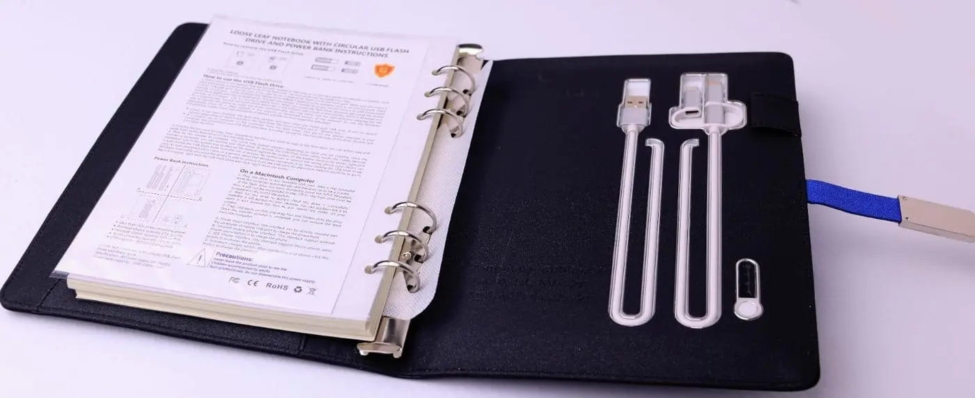 Black ring-bound organiser with card slots and charging cables, Hensa
