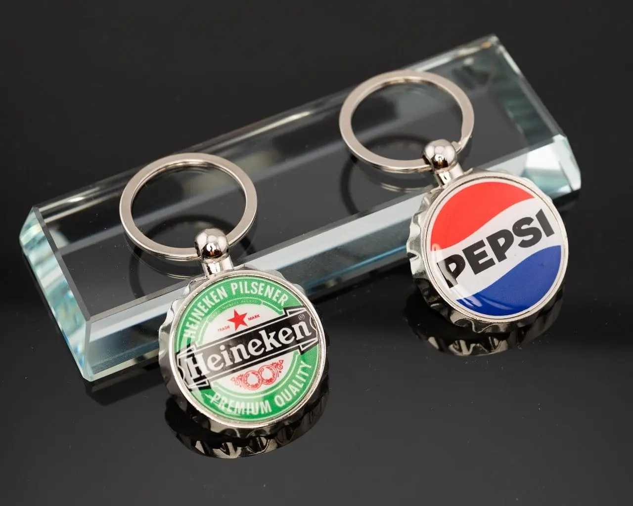 Two crown-cap shaped printed keyholders, Hensa