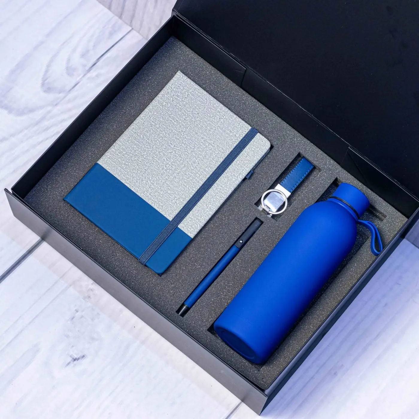 Blue and grey notebook, water bottle, pen and keyholder in a black gift box, Hensa