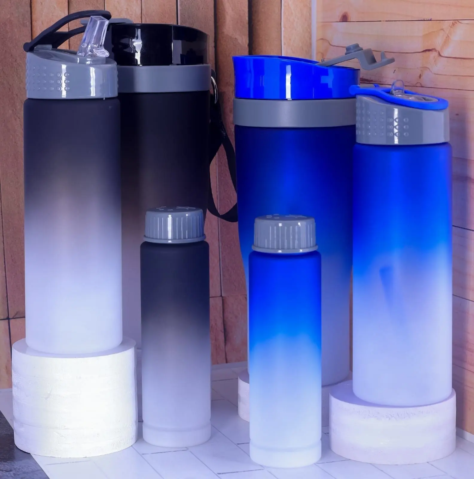 Black and blue colour-fade plastic water bottles in tall and short sizes, Hensa