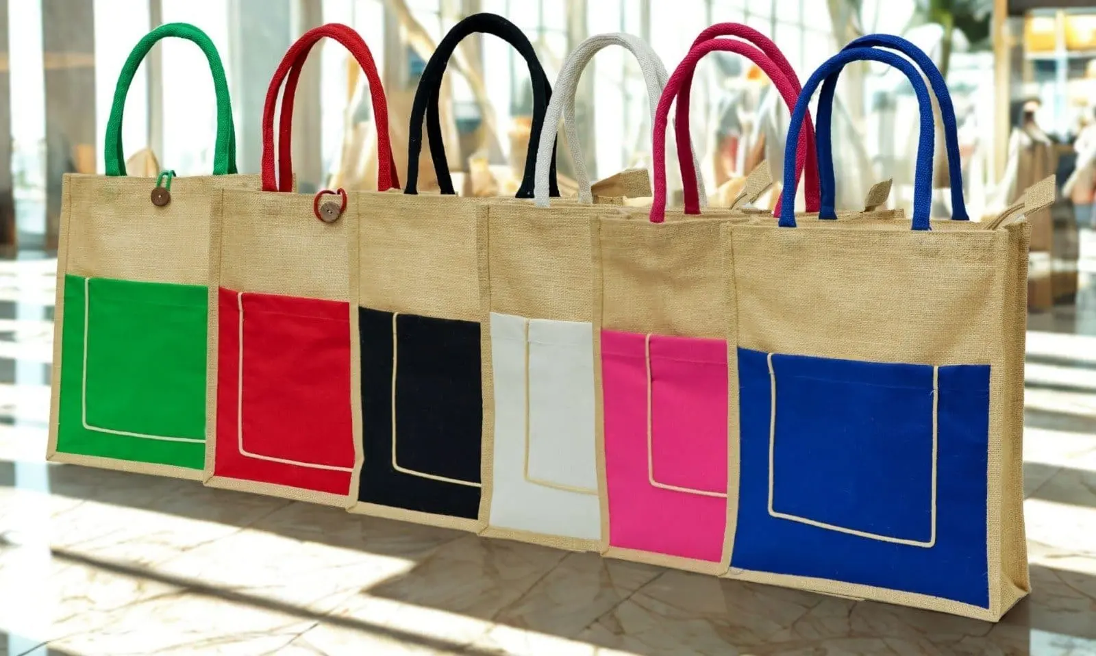 Six upright A4 jute bags with green, red, black, white, pink and blue front pockets, Hensa