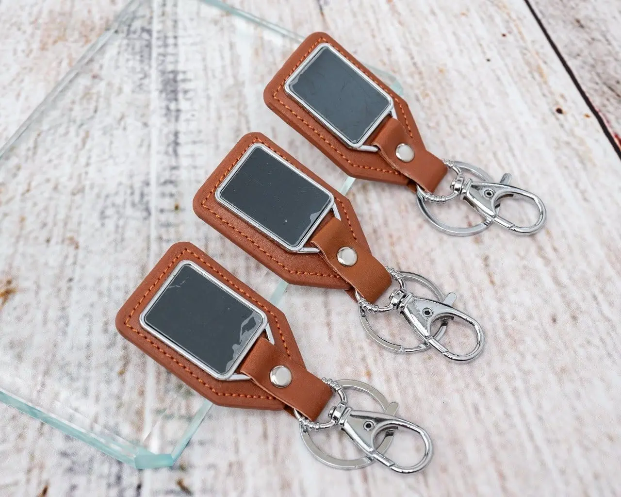 Three brown leather shield keyholders, Hensa