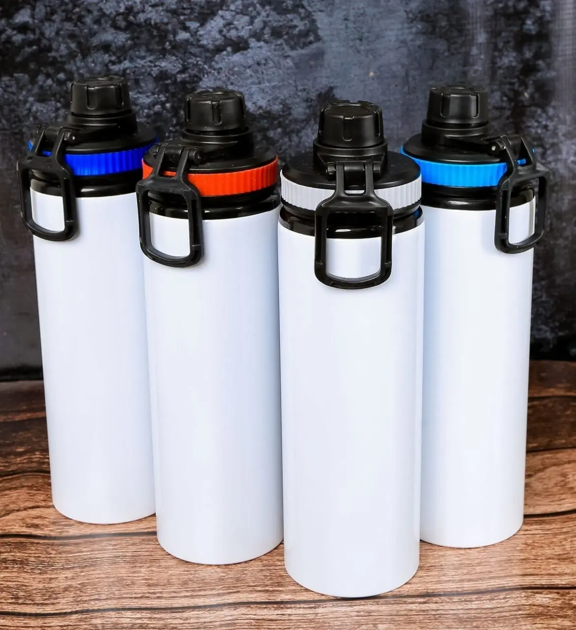 Four white metal water bottles with black caps, carry loops and coloured rings, Hensa