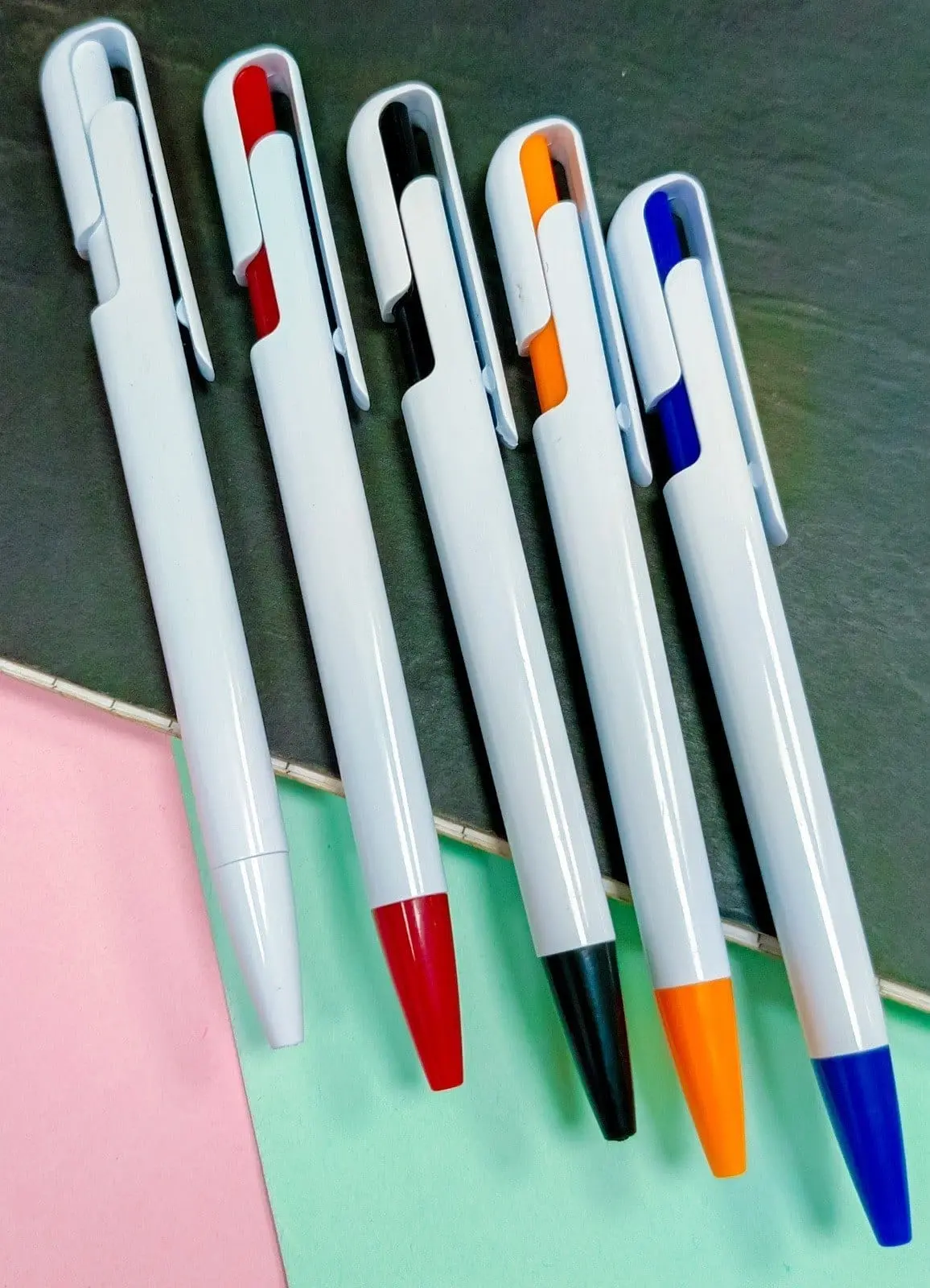 Five white plastic click pens with coloured clip and tip accents, Hensa