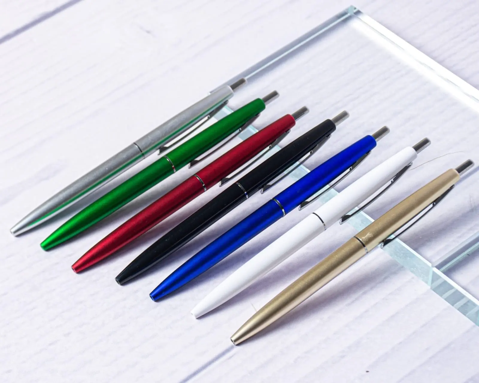 Plastic pens in several colours on a glass display, Hensa