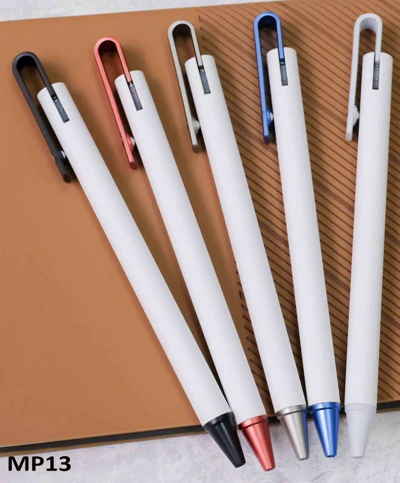 Five click pens with white barrels and black, red, silver, blue and grey clips and tips, Hensa