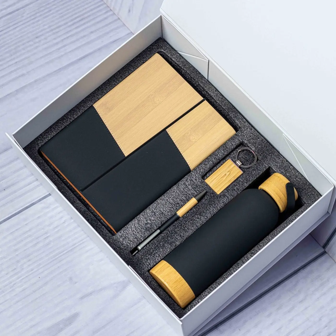 Black bamboo notebook, card holder, bamboo-top bottle, pen and keyholder in a white gift box, Hensa