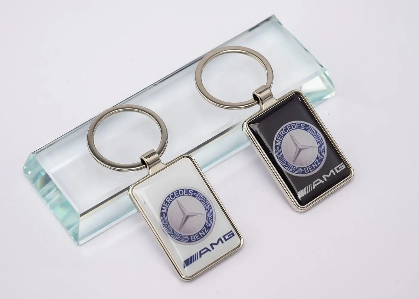 Two rectangular metal keyholders with domed inserts, Hensa